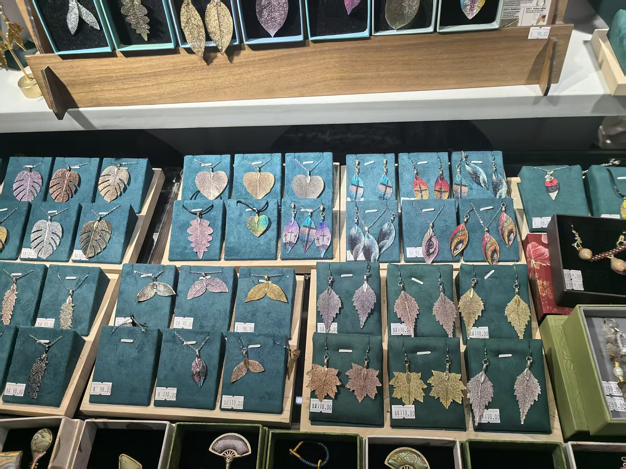 Real wholesale display of botanical leaf earrings and pendants