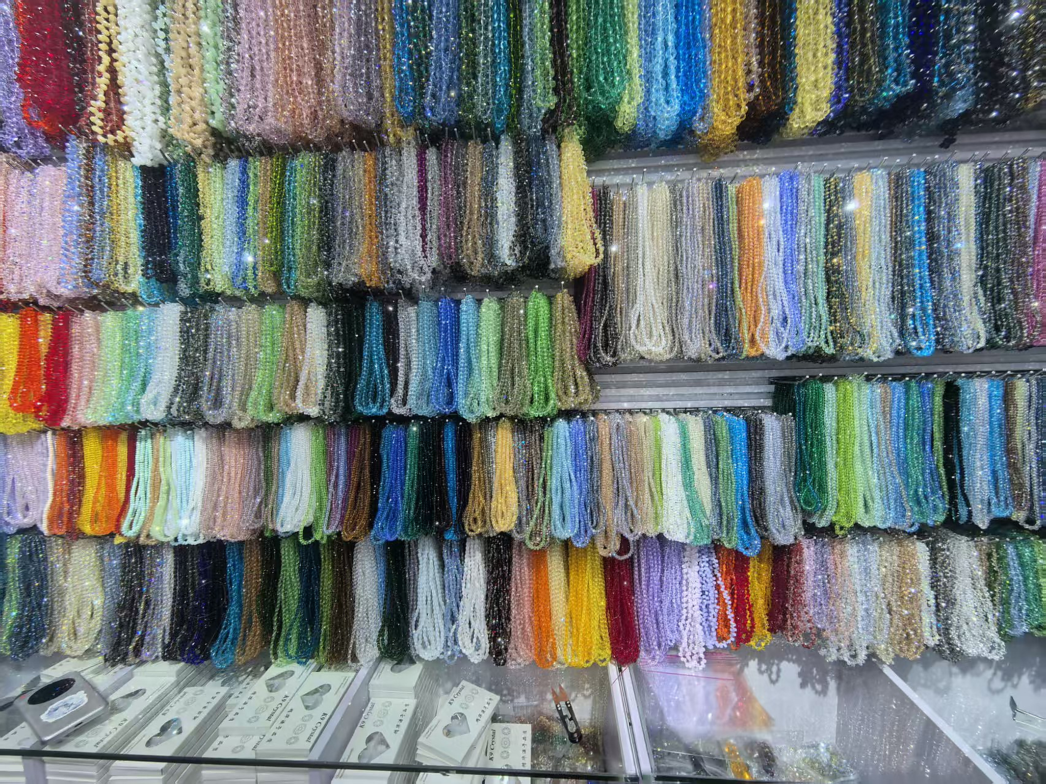 Real wholesale display wall with many colors of faceted crystal bead strands